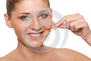 Woman taking off her skin from face photo