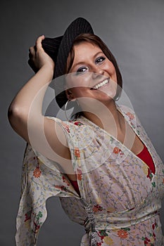 Smiling brunette young woman with a hat