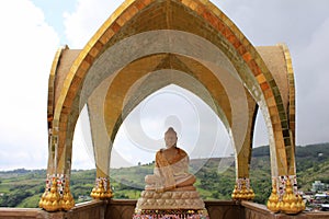 Smiling Buddha on one of the levels of Pha Sorn Kaew under a golden dome, at Pha Sorn Kaew, in Khao Kor, Phetchabun, Thailand photo