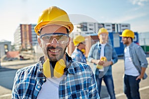 Smiling builder with hardhat and headphones