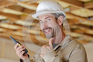 smiling builder in hardhats showing thumbs up