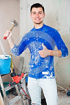 Smiling builder showing thumb up