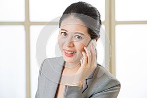 Smiling Business asian Woman talking on a Mobile phone