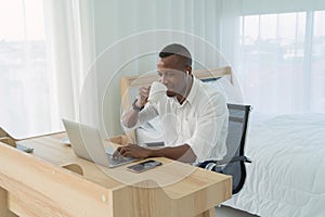 Smiling business black american man, African person working from home and drinking coffee with computer notebook laptop on webcam