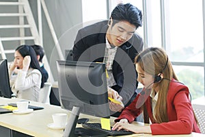 Smiling Business Call Center and technical Support staff or receptionist phone operator Discussing and working for teamwork with