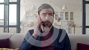 Smiling business man having good news on phone. Happy man at home office.