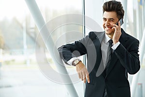 Smiling Business Man Talking on Mobile Phone