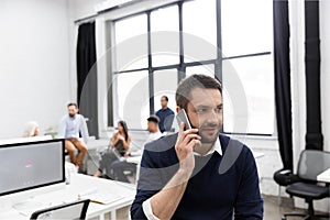 Smiling business man talking on mobile phone