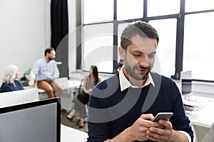 Smiling business man talking on mobile phone