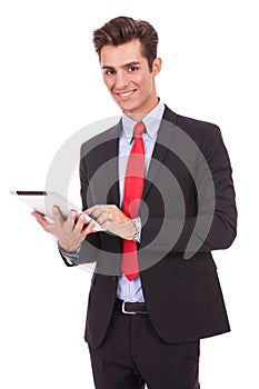 Smiling business man using his tablet pad