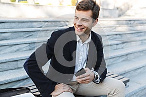 Smiling business man using mobile phone