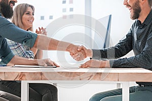 Smiling business partners shaking hands . concept of partnership