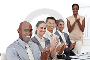 Smiling business people applauding