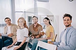 smiling business people in casual clothing having business training