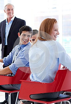 Smiling business people discussing at a conference