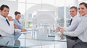 Smiling business people in front of a blank whiteboard