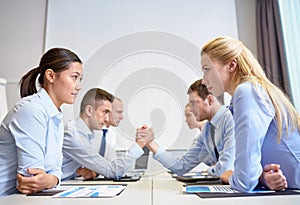 Smiling business people having conflict in office