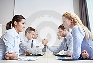 Smiling business people having conflict in office