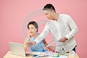 Smiling business people using a computer in their office