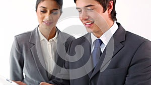 Smiling business people using a tablet pc