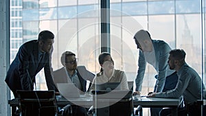 Smiling business people working as a team at a desk in a meeting room