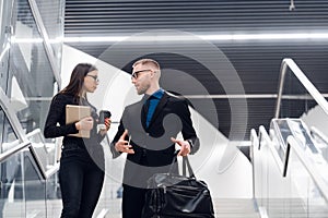 Smiling business team members talking during coffee break, young businessman and businesswoman having pleasant