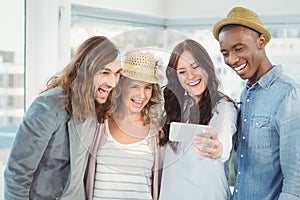 Smiling business team taking selfie at office