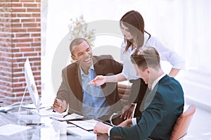 Smiling business team talking ,sitting at their Desk