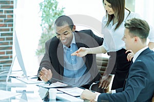 Smiling business team talking ,sitting at their Desk