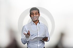 Smiling business trainer holding digital tablet and looking at camera.