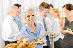 Smiling business woman during company lunch buffet