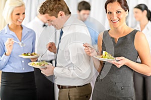 Smiling business woman during company lunch buffet