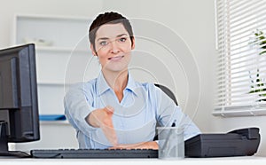 Smiling business woman giving her hand