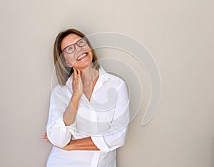 Smiling business woman with glasses looking up