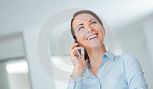 Smiling business woman having a phone call