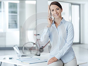 Smiling business woman having a phone call