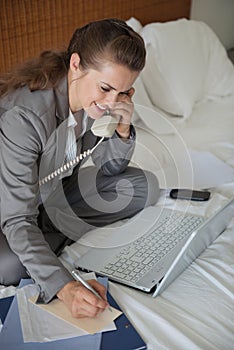 Smiling business woman having working phone calls