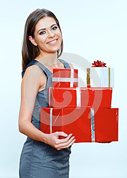 Smiling business woman hold pile of gifts. Red gift box.