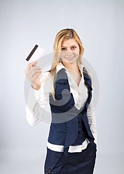 Smiling business woman holding a bank card