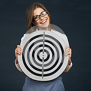 Smiling business woman holding black white target.