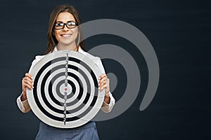 Smiling business woman holding black white target.