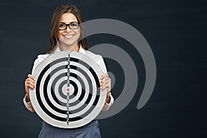 Smiling business woman holding black white target.