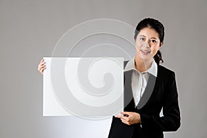 Smiling business woman holding blank board