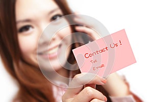 Smiling business woman holding a card (Contact Us) photo