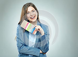 Smiling business woman holding passport with ticket.