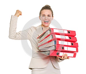 Smiling business woman holding stack of folders