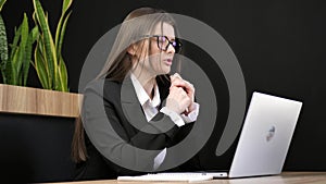 Smiling business woman holding a video conference on a laptop. call center agent, HR manager conducting remote chat