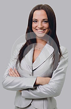 Smiling business woman, Isolated on gray background. crossed arm