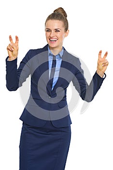 Smiling business woman making finger quote marks