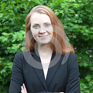 Smiling business woman in a park photo